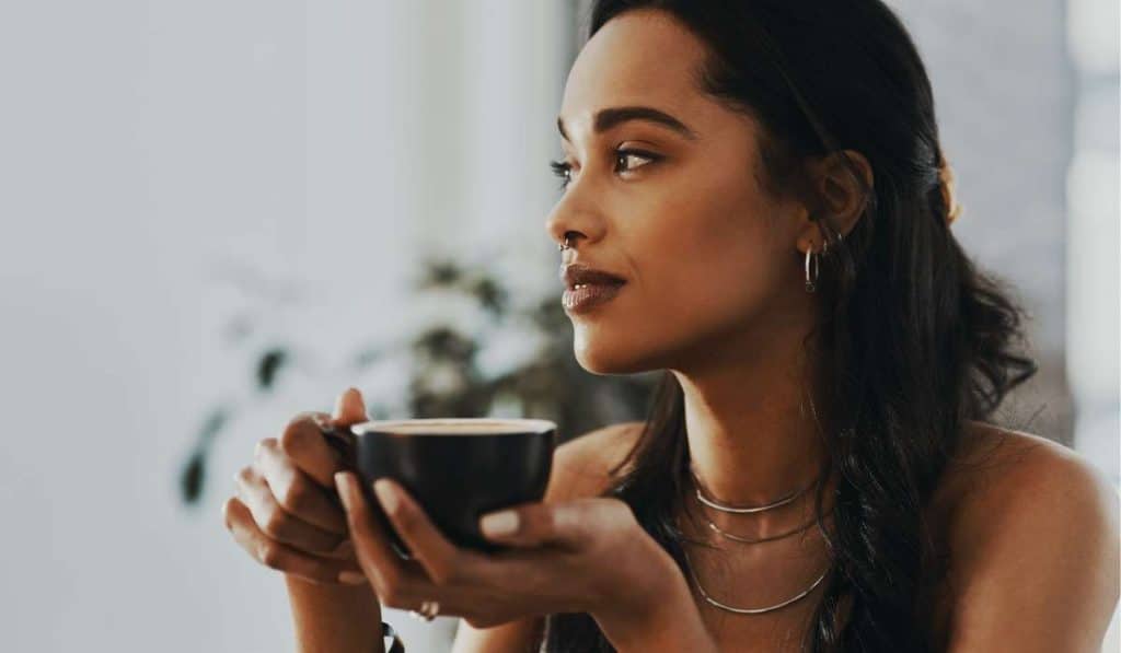 Calm woman holding a cup or tea. Hyperthyroidism. Brisbane Livewell Clinic
