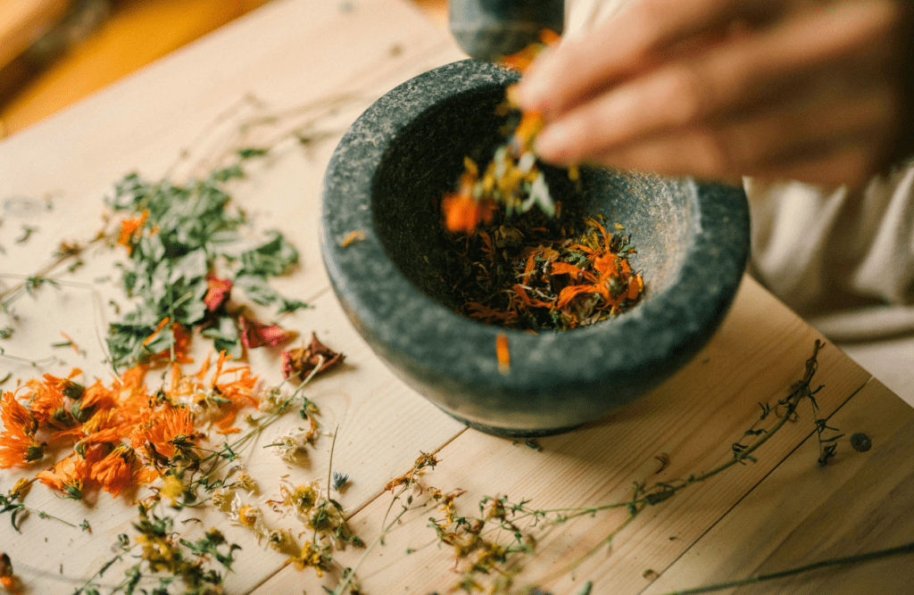 Person grinding herbs in a mortar. Natural Dispensary. Brisbane Livewell Clinic