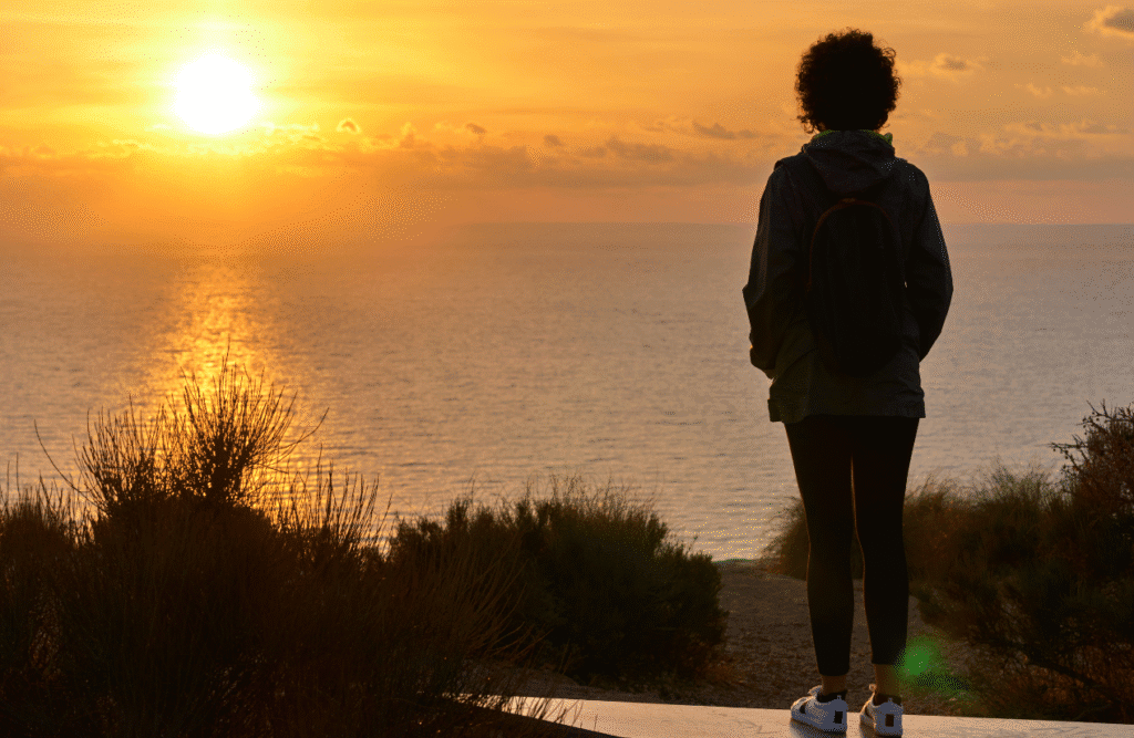 Person looking at the sunrise over the sea. Natural Therapies Brisbane. Brisbane Livewell Clinic