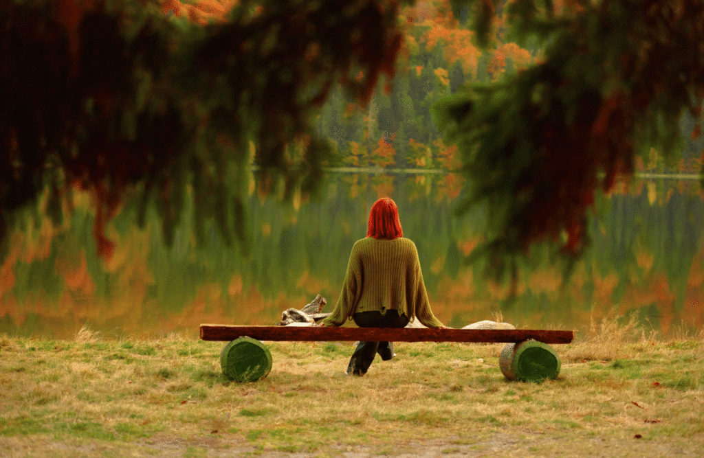 Woman sits on a bench beside a lake. Natural Therapies Brisbane. Brisbane Livewell Clinic