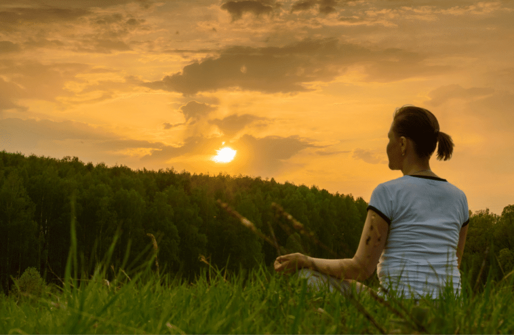 Woman meditates in nature. Natural Therapies Brisbane. Brisbane Livewell Clinic
