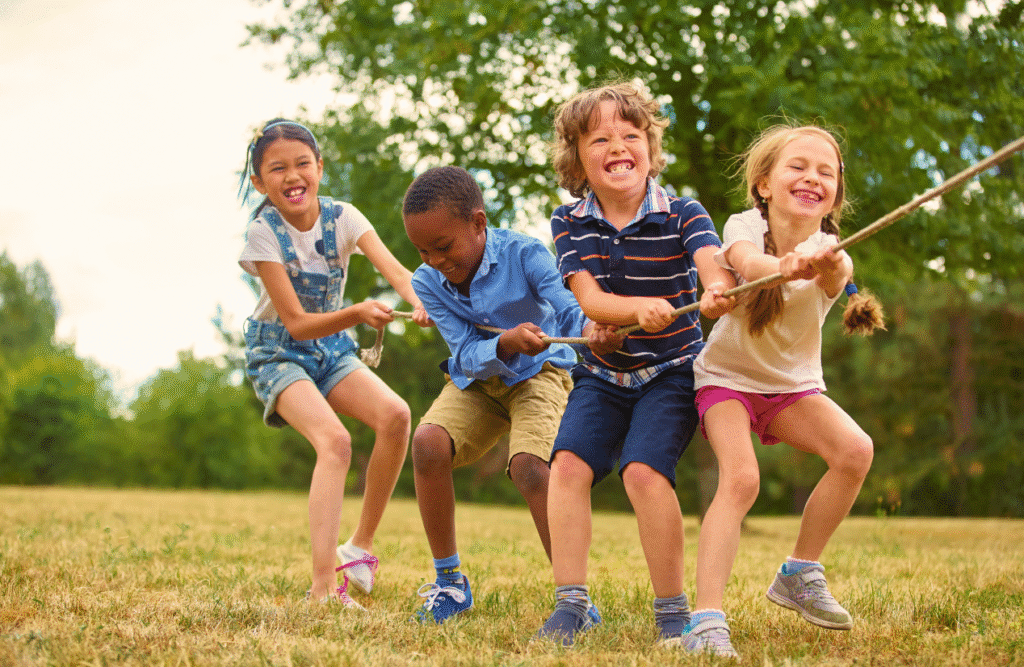 Kids playing tug of war game in the park. ADHD Naturopath. Brisbane Livewell Clinic. Child's Naturopath. Kinesiology