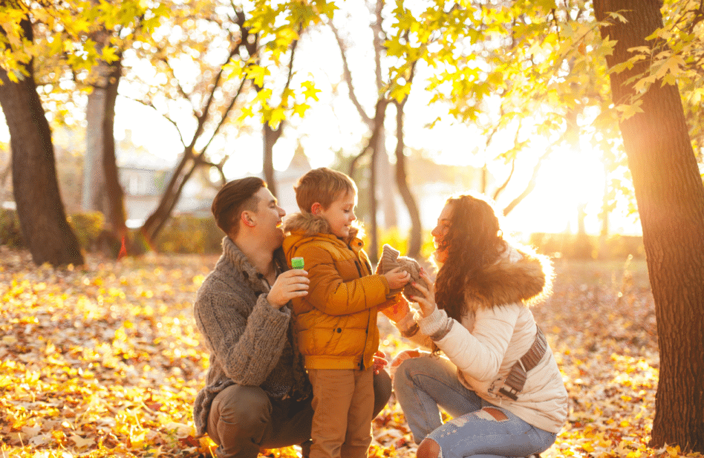 Family having fun outdoors in an autumn park. Health Screening. Brisbane Livewell Clinic. Improving mental health with Naturopathy. How can Naturopathy improve my mental health?