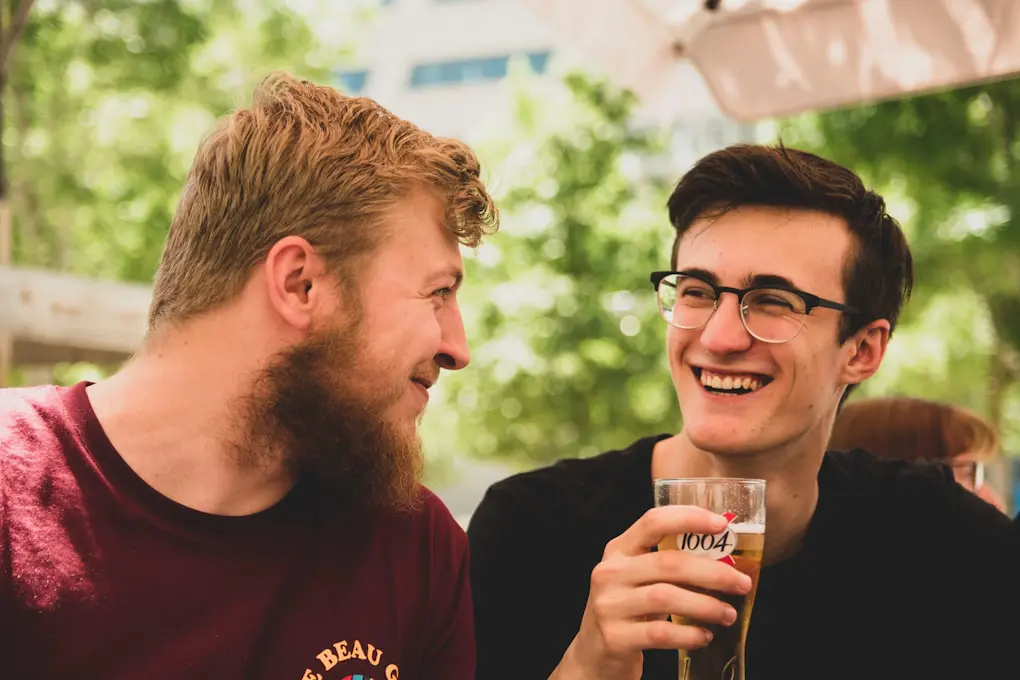 Two men smiling over a beer, Counselling Wavell Heights
