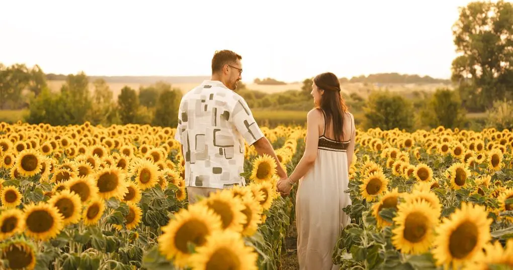 A couple walking through a sunflower field. Brisbane Holistic Counselling with Nathan Gurry