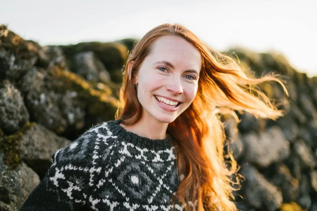 Young woman with long red hair smiling brightly outdoors. Nutritionist Wavell Heights. Brisbane Livewell Clinic