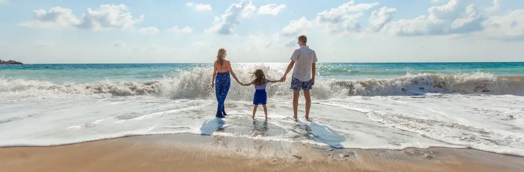 Family walking on the beach. Holistic Counselling Brisbane