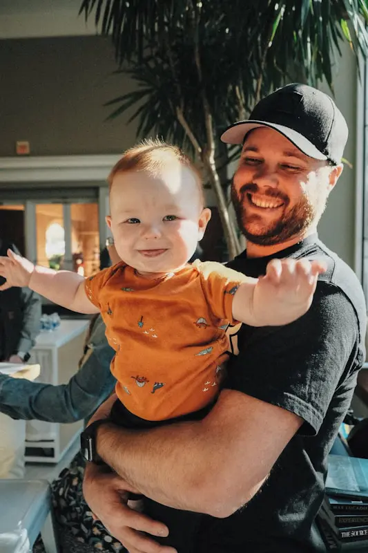 Father holding his laughing baby. Holistic Counselling in Brisbane