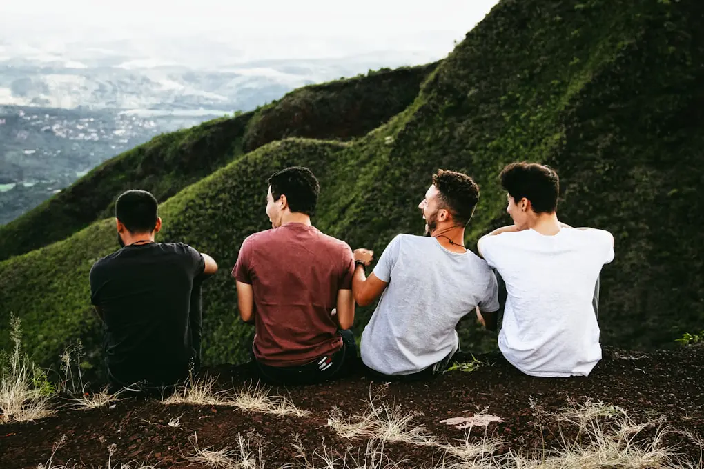 Four men sitting on mountain trail. Jeremy Walker - Hypnotherapist Brisbane