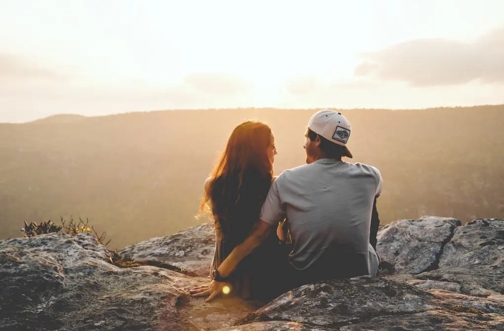 Couple sitting on a rock after Holistic Counselling Brisbane