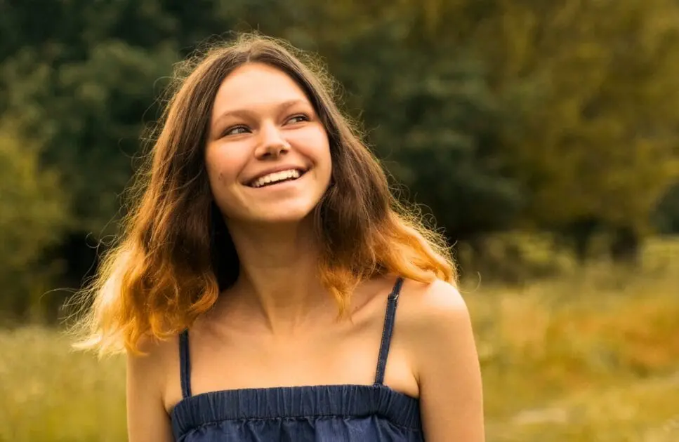 Smiling teenage girl standing in a field. Chronic Fatigue Treatment Brisbane. Holistic Counselling for Sensory Overload. Guide to Your First Osteopath Appointment. Brisbane Livewell Clinic