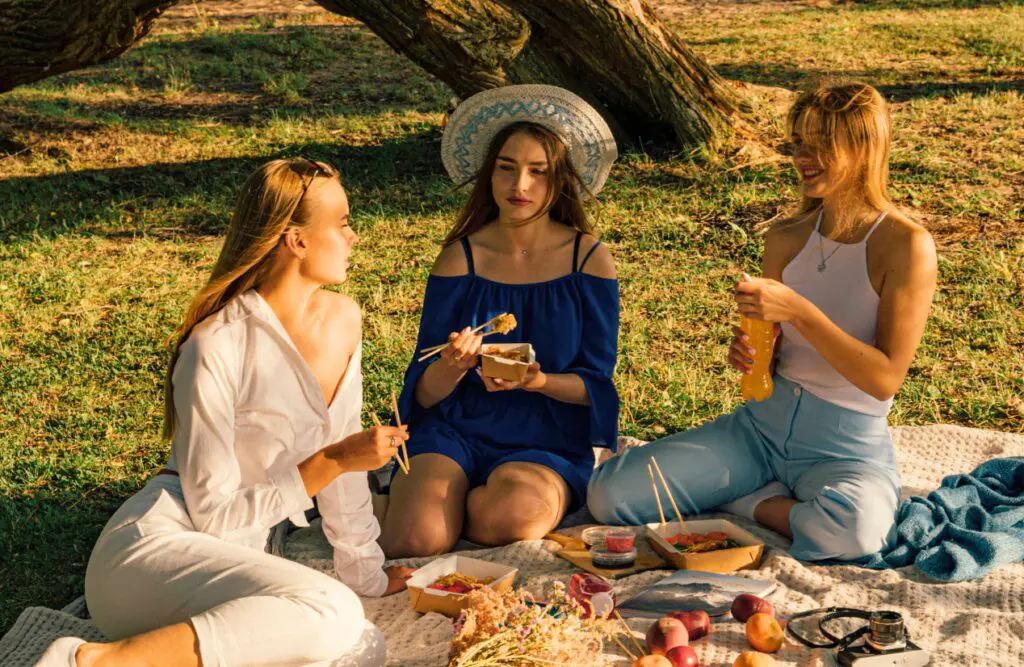 Women sitting on the picnic blanket on the park. Clinical Nutritionist Carina. Brisbane Livewell Clinic