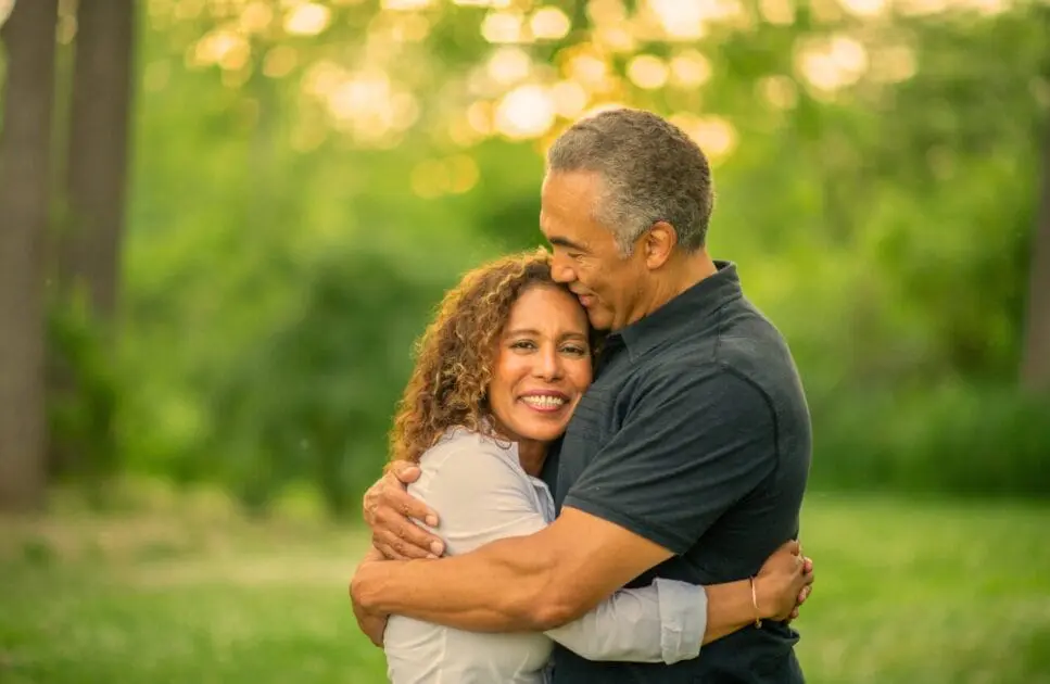 Husband and wife shares a warm embrace in a park. Marriage Counselling Brisbane. Marriage Counselling Near Me. Brisbane Livewell Clinic