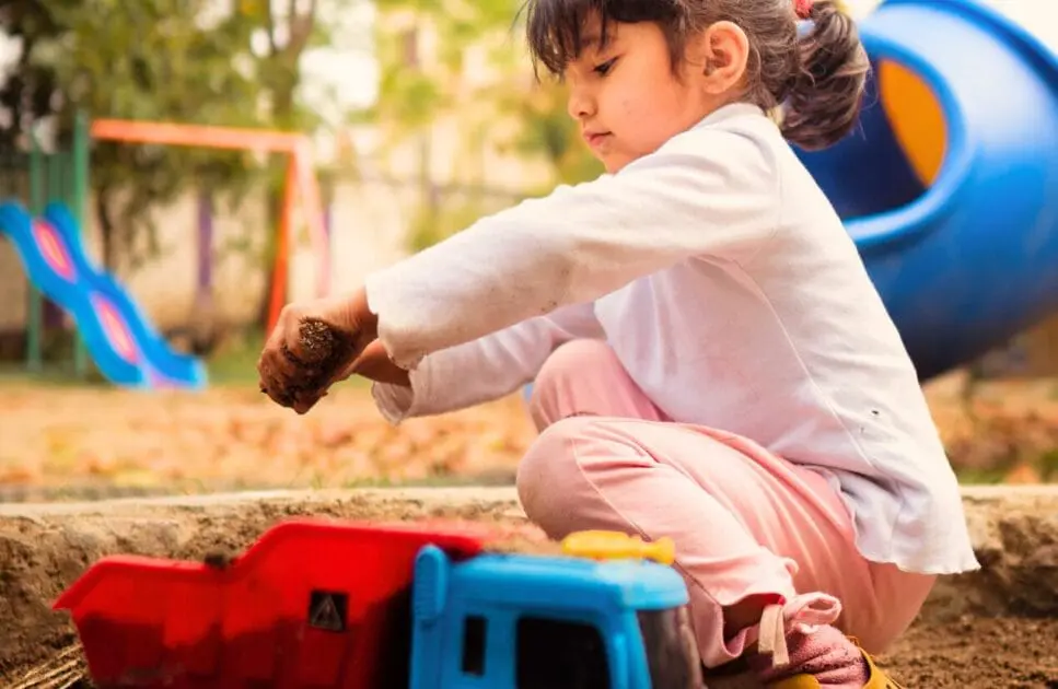 Little girl playing with soil. Dealing with Parasites living within you. Brisbane Livewell Clinic