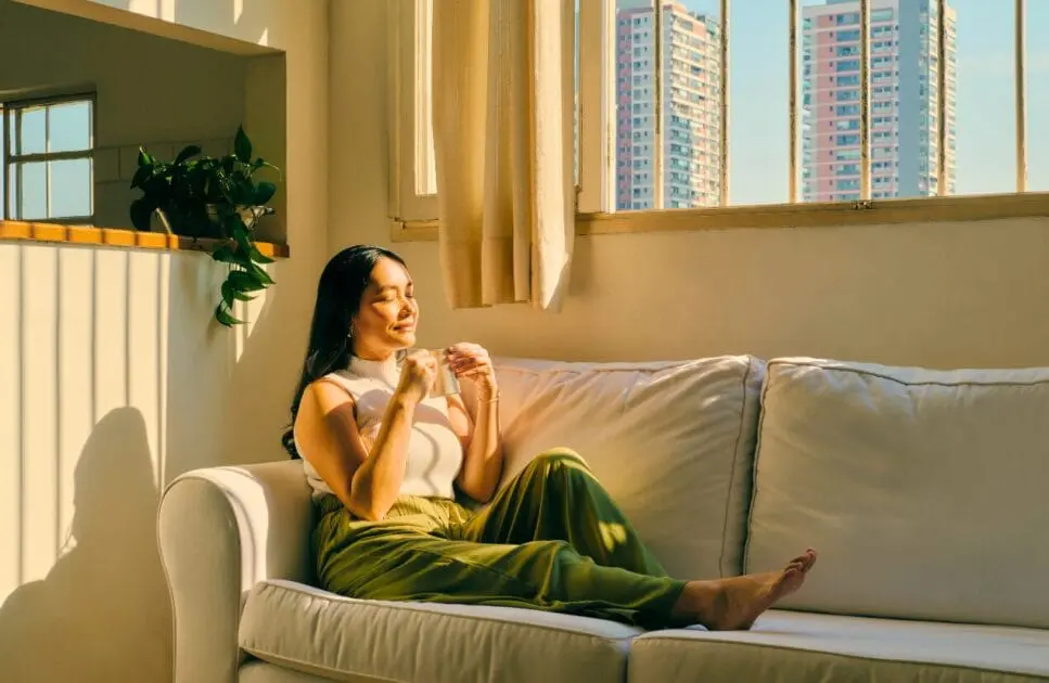 Woman having coffee on the couch. Naturopathy Brisbane. Leaky Gut Syndrome. Meaning of Hypnosis. Clinical Nutritionist Cannon Hill. Holistic Counselling Brisbane. Brisbane Livewell Clinic