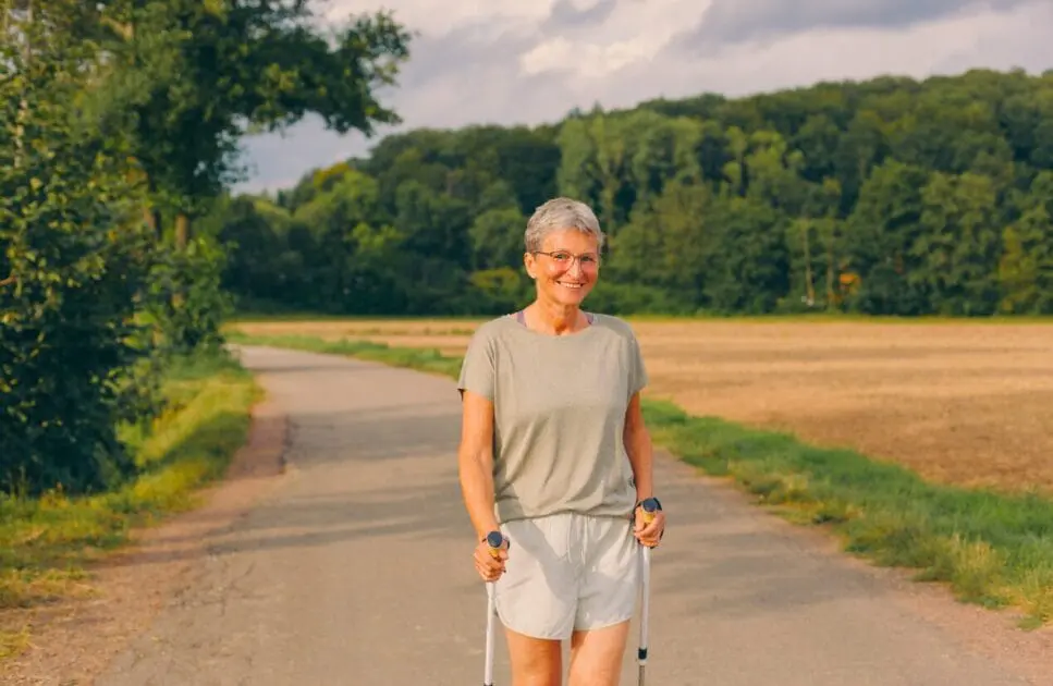 Middle-aged woman hiking outdoors. Lifestyle Changes Women Need. Exercise. Osteopathy for Arthritis and Joint Stiffness. Osteopath for Posture and Alignment. Osteopathy and Knee Pain. Brisbane Livewell Clinic