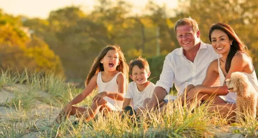 Family sitting in a park at sunset. Brisbane Livewell Clinic | Naturopath Brisbane, Wellness Centre, Allied Health, Natural Therapies - Wavell Heights & Cannon Hill. Leaky Gut Syndrome. Suzanne Wilson