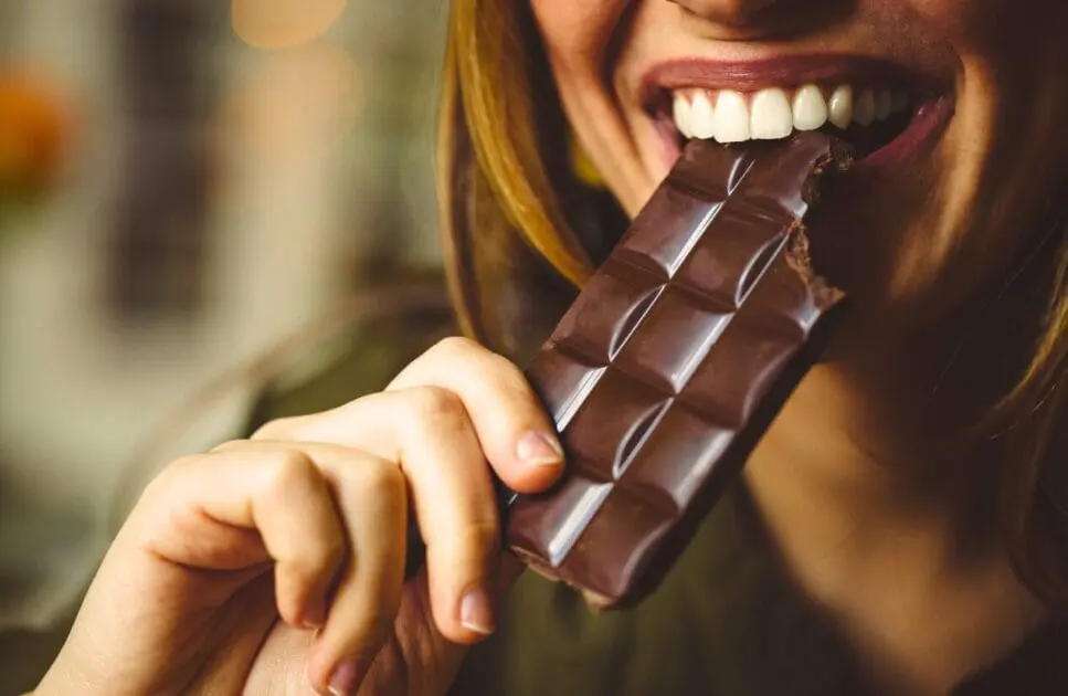Woman eating chocolates. Causes of Constipation. Appetite. Brisbane Livewell Clinic