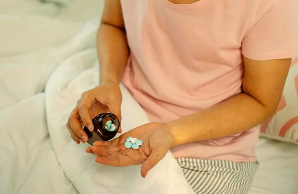 Person holding a bottle of painkillers. Causes of Constipation. Brisbane Livewell Clinic