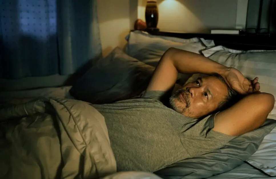 Man lying in the bed at night. Solving Insomnia Through Naturopathy. Sleep. Brisbane Livewell Clinic