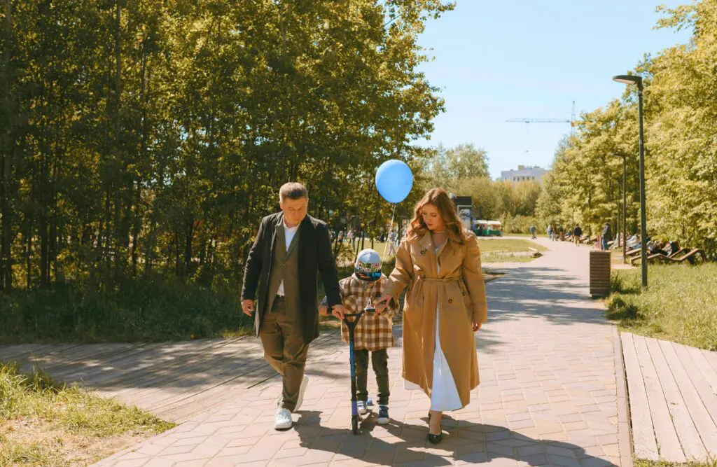 Parents walking with their son riding on the scooter. Counselling Aspley. Brisbane Livewell Clinic
