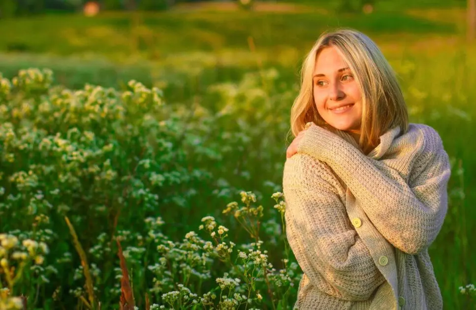 Smiling woman standing in a flower field. Hypnotherapy near Chermside. Naturopath Blood Test. Hypertension. Meaning of Hypnosis. Holistic Counselling for Common Concerns in Brisbane. Brisbane Livewell Clinic