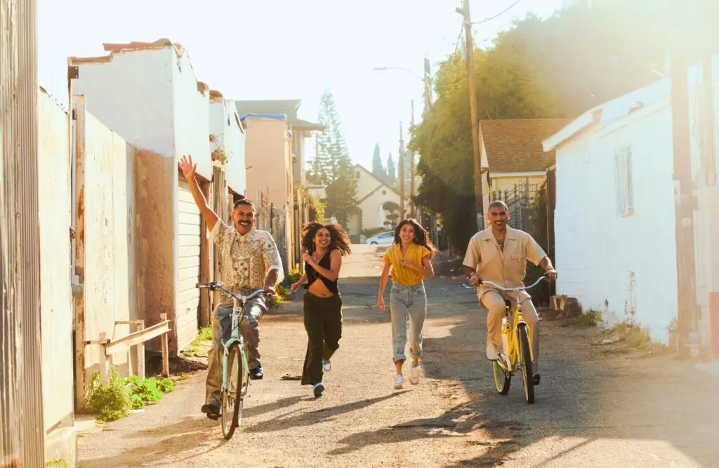 Group of friends enjoying a sunny day, with two riding bicycles and two running. Addiction Hypnotherapy. Osteopathy vs Chiropractic vs Physiotherapy. Brisbane Livewell Clinic