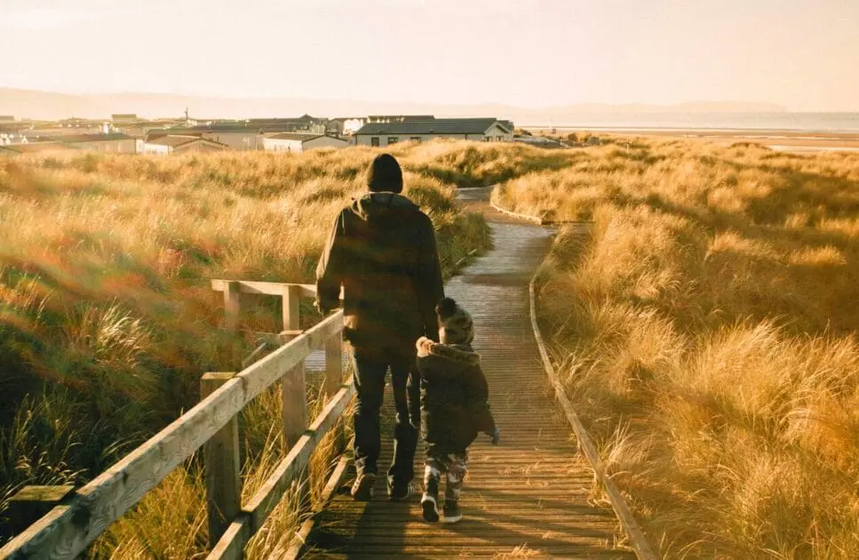 Father and his child walk hand in hand along the boardwalk. Hypnotherapy near Wooloowin. Brisbane Livewell Clinic