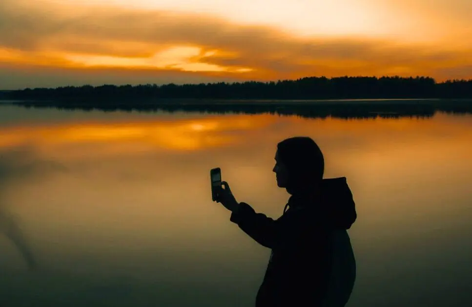 Silhouette of a person taking a photo of the sunset. Hypnotherapy near Stafford. Brisbane Livewell Clinic