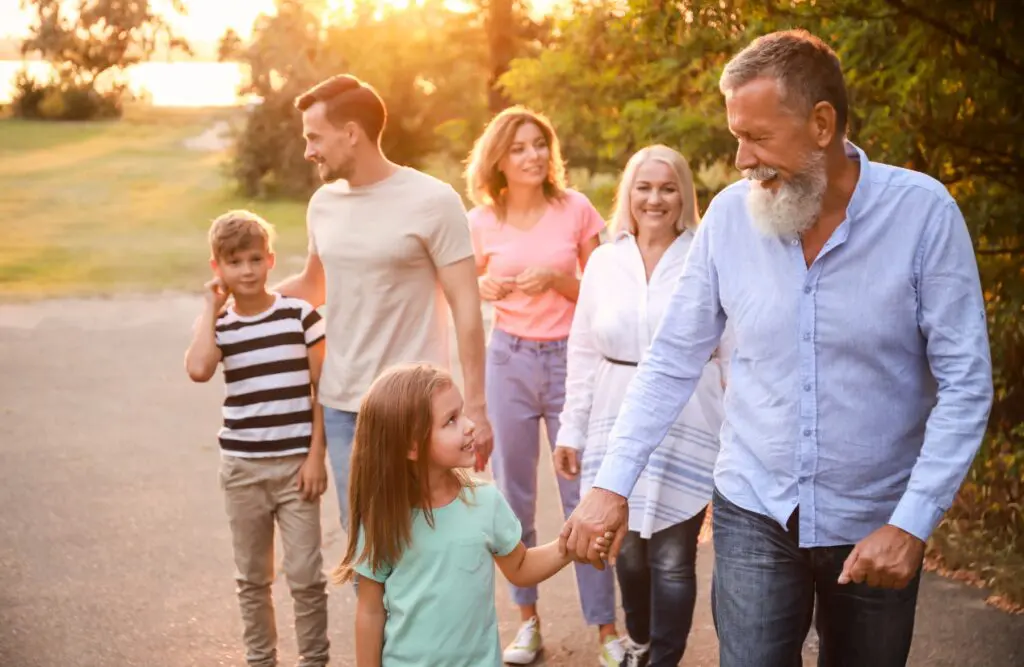 A happy family walking together outdoors at sunset. Naturopath North Brisbane. Therapists Brisbane. Hypnotherapy for Smoking. Hypnotherapy to Quit Smoking. Brisbane Livewell Clinic