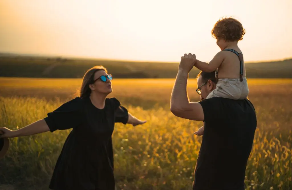 Family enjoying time outdoors in a sunlit field. Food Intolerance Testing Brisbane. Brisbane Livewell Clinic