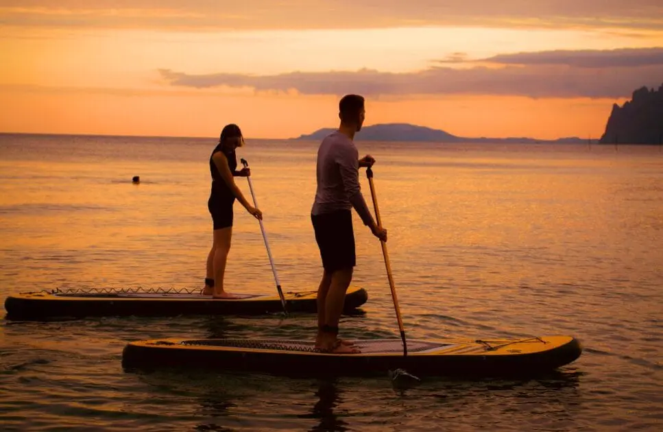 Man and a woman paddle boarding together on a calm ocean. Hypnotherapy near Virginia. Brisbane Livewell Clinic. Marriage Counsellor Near Me