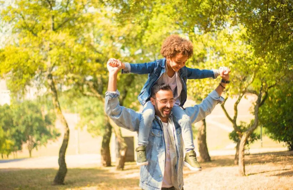 Father carrying his son on his shoulders while having fun in the park. Hypnotherapy near Chermside. Family Counselling. Bowen Therapy Cost. Osteopath for Shoulder Pain and Arm Discomfort. Brisbane Livewell Clinic