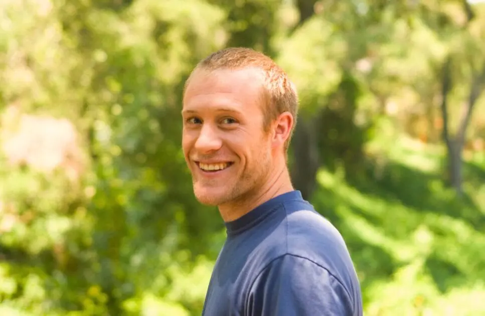 Smiling man standing in a park. Naturopathic Anxiety Medication. Clinical Hypnotherapy. Hypnotherapy Wavell Heights. Hypnosis in Wavell Heights. Osteopathy and Sleep Support. Brisbane Livewell Clinic