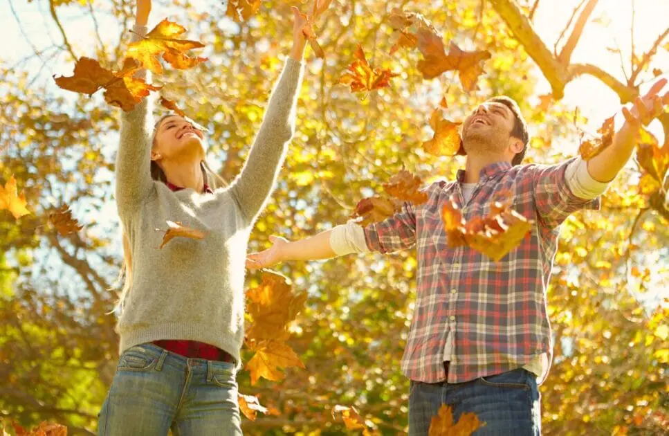 Man and woman tossing leaves into the air. Couples Counselling Brisbane. Brisbane Livewell Clinic
