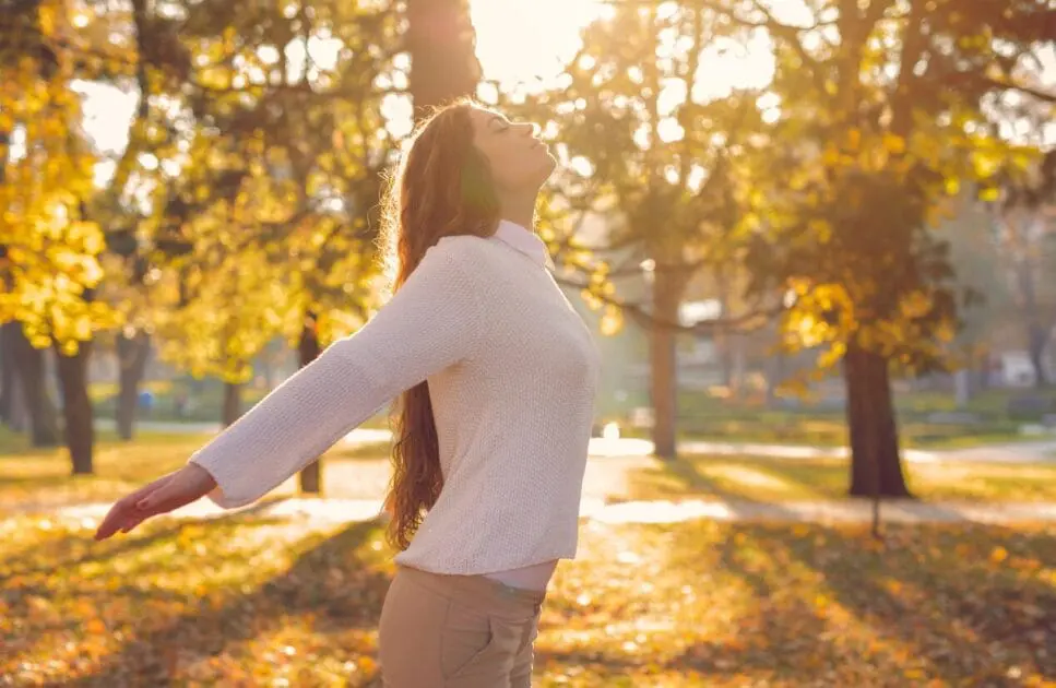 Woman is taking a deep breath with her arms outstretched. Grief Counselling. Breathing. Leaky Gut Syndrome. Brisbane Livewell Clinic. Breathing techniques for anxiety relief. Breathing to relieve anxiety