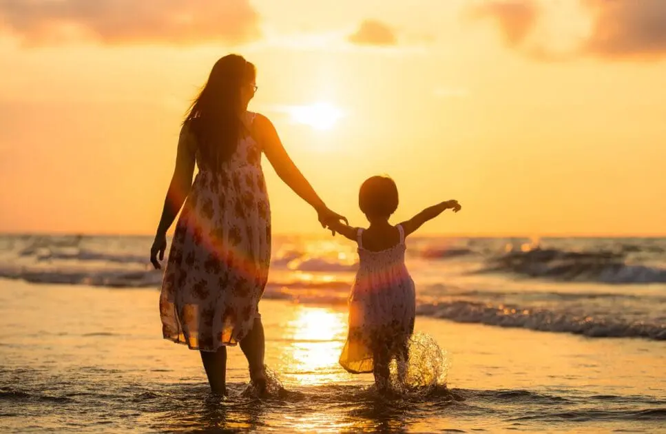 Mother and daughter walking on the beach at sunset. Genetic Methylation Test. FAQS. Brisbane Livewell Clinic