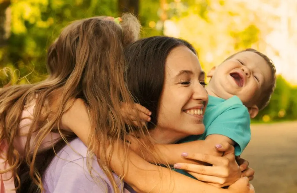 Joyful moment of a smiling mother embracing her two children. Hypnotherapy near Geebung. Does Bowen Therapy Actually Provide Relief. Brisbane Livewell Clinic